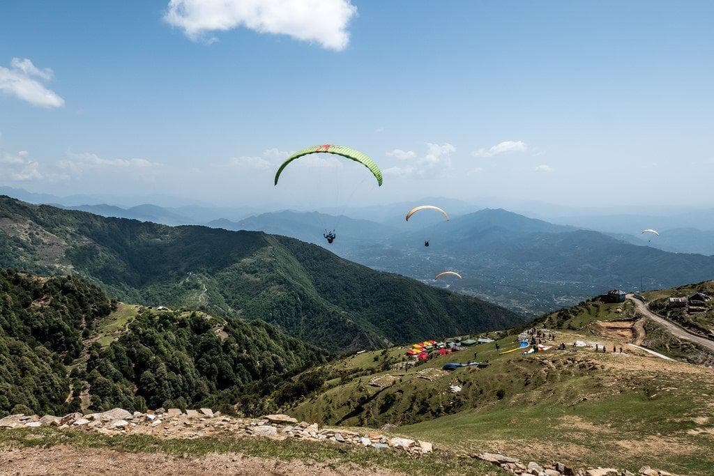 Paragliders above the Dhauladhar foothills