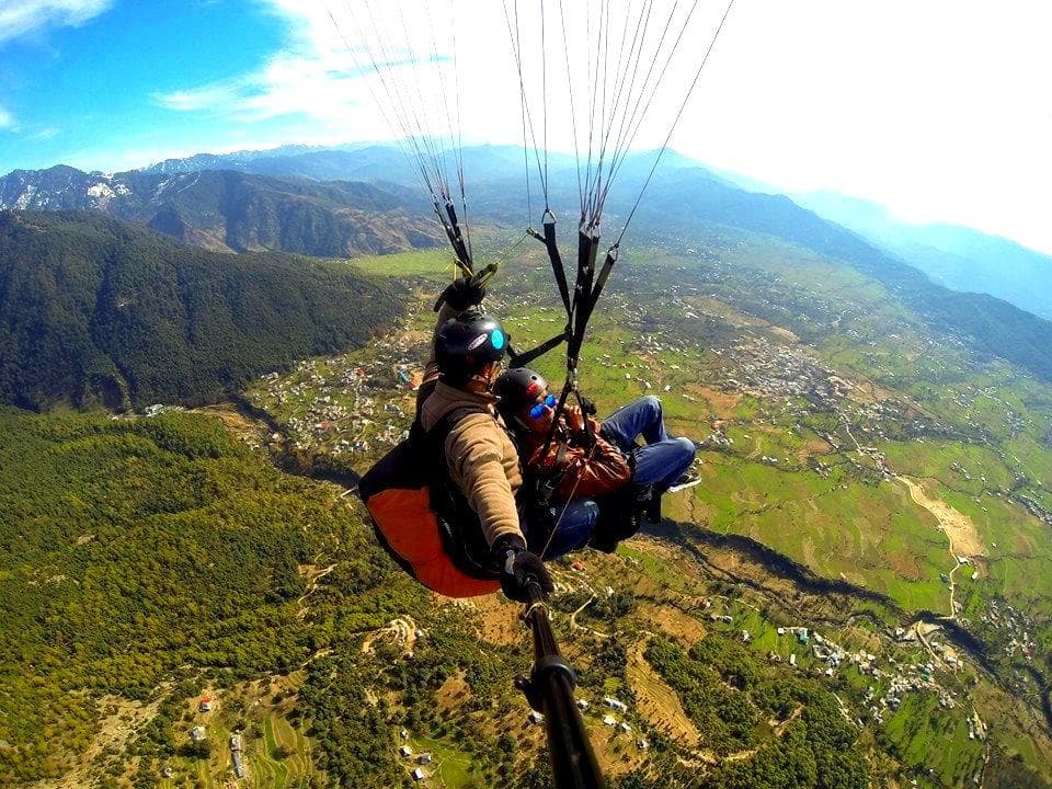 Tandem paragliding above Bir